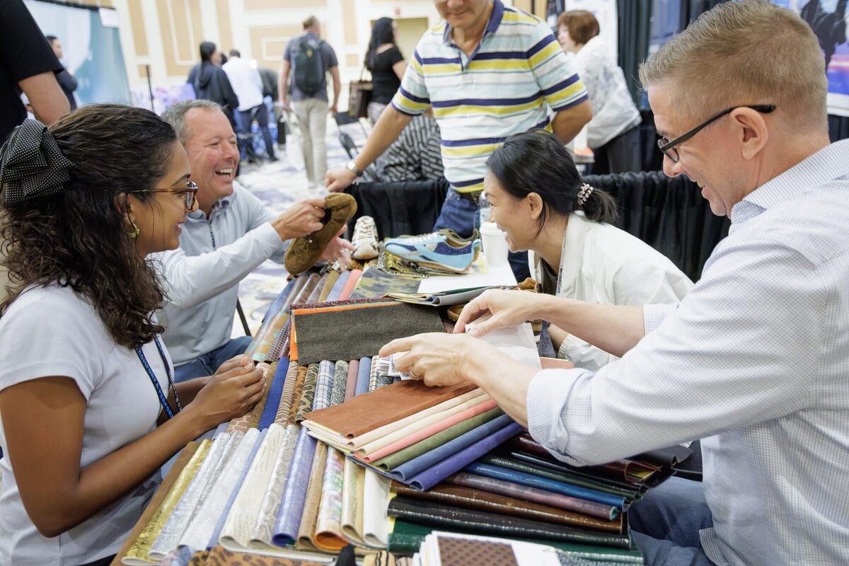 Fabric samples spread across a booth table.