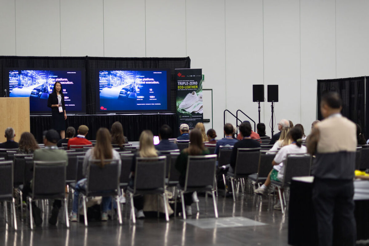 An audience watching a presentation on the show stage.