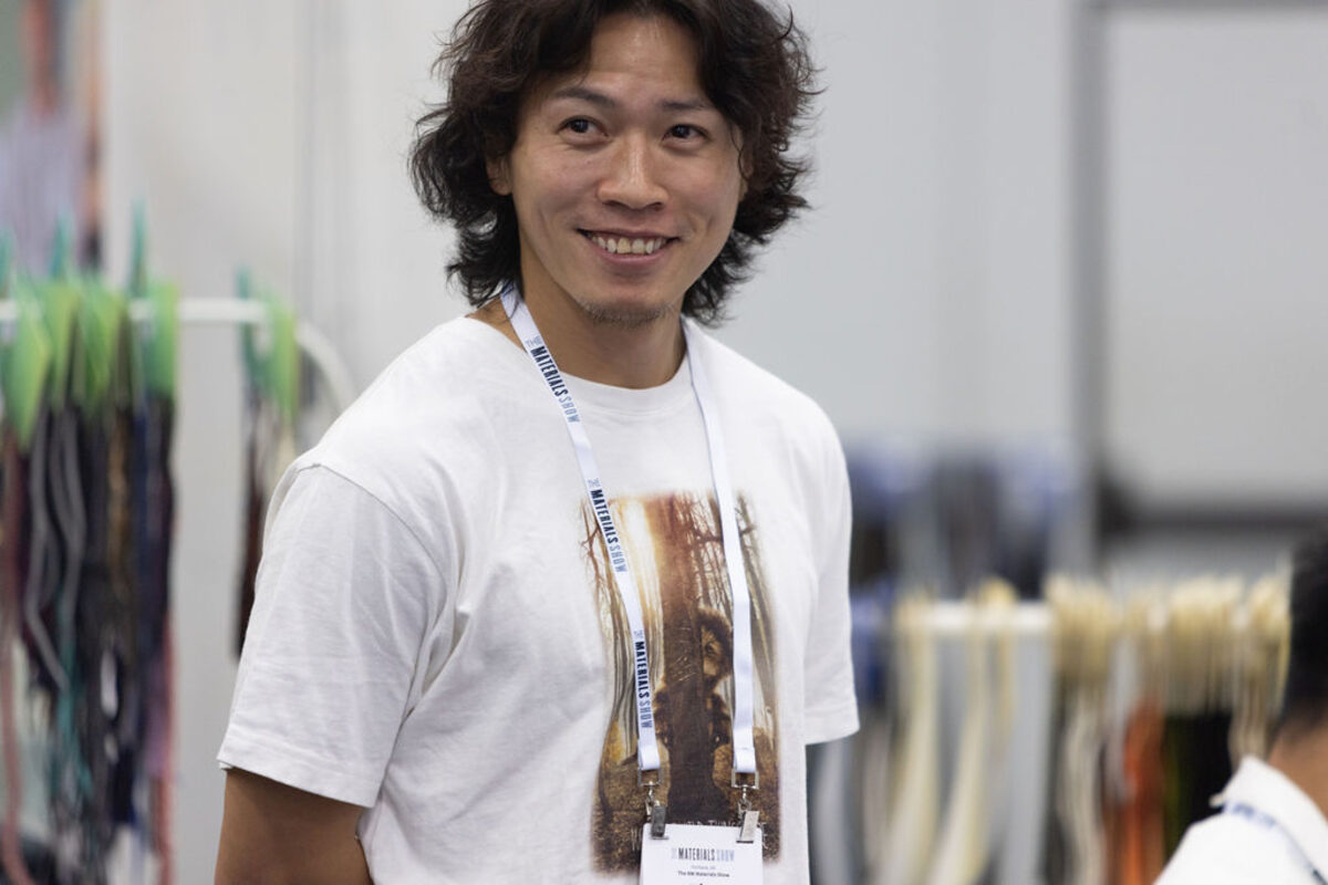 A smiling attendee on the show floor.